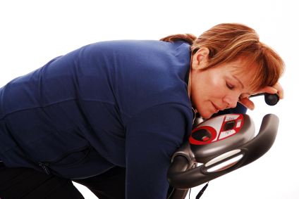Woman sleeping on exercise bike